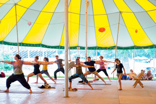 Yoga under the dance tent at Grassroots Culture Camp